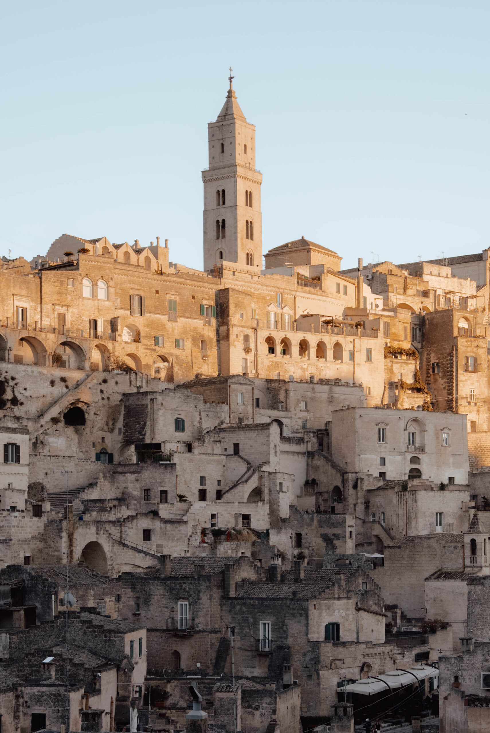 Best sunset view of Matera Italy showing layered cave dwellings carved into limestone cliffs